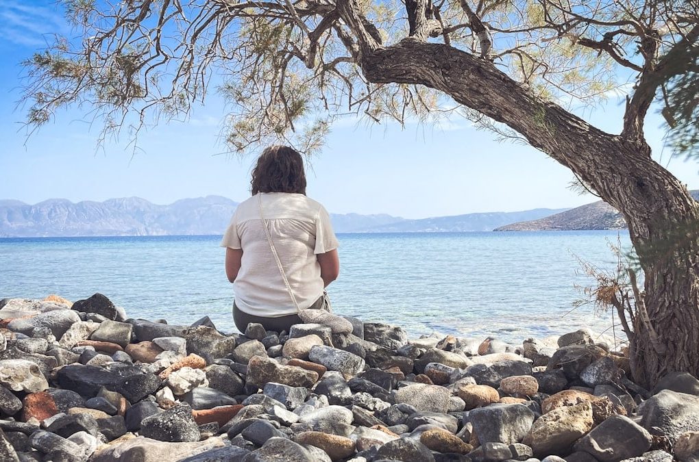 A person sits and enjoys the scenic seaside view.