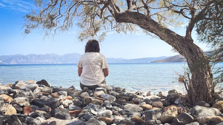 A person sits and enjoys the scenic seaside view.